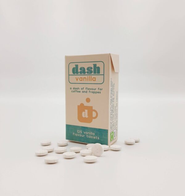 box of dash flavour tablets with some tablets scattered beside it.