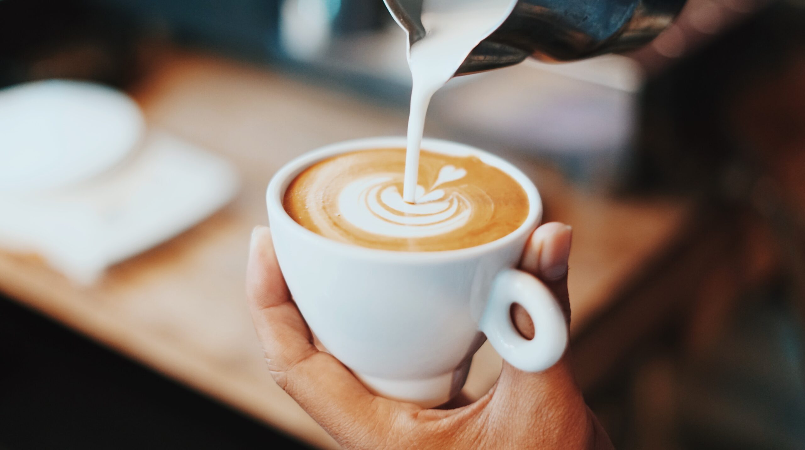 coffee with milk art made on a home barista course